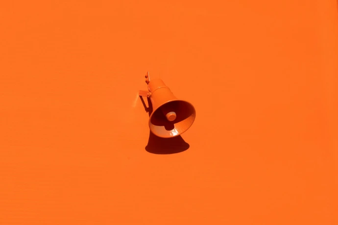 orange megaphone on orange wall